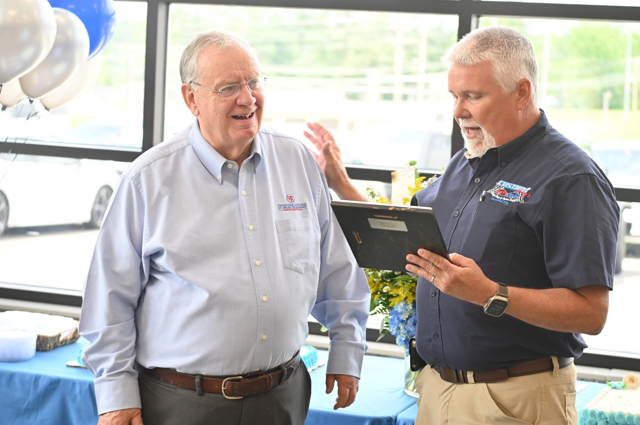 Dwight Murphy is presented a plaque by Scott County Industrial Development Board chairman Greg Jeffers.